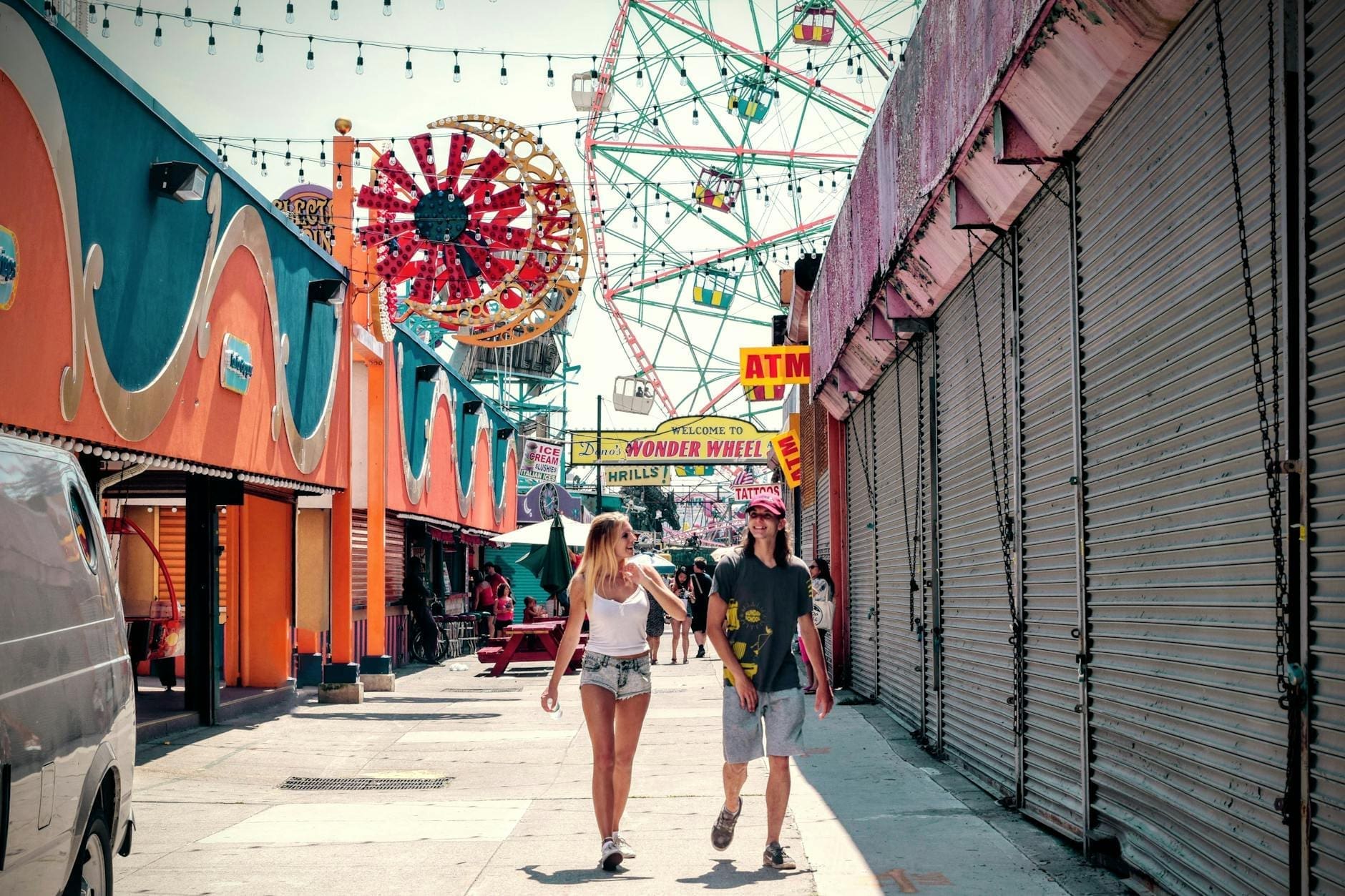 woman and man walking in the carnival during daytime