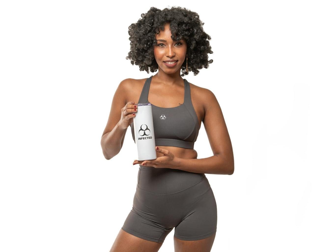 woman holding sports bottle in activewear