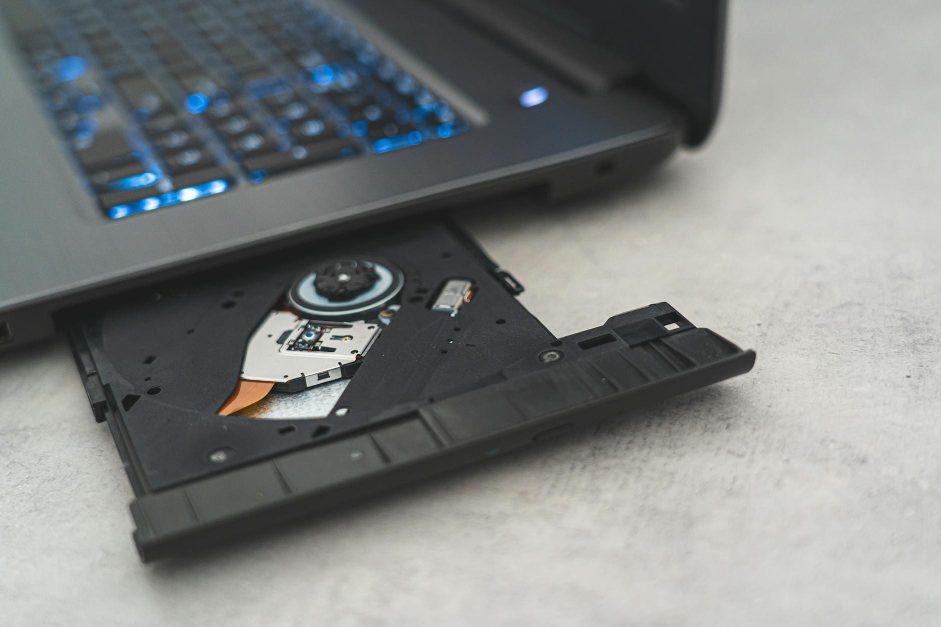 black laptop computer on white textile
