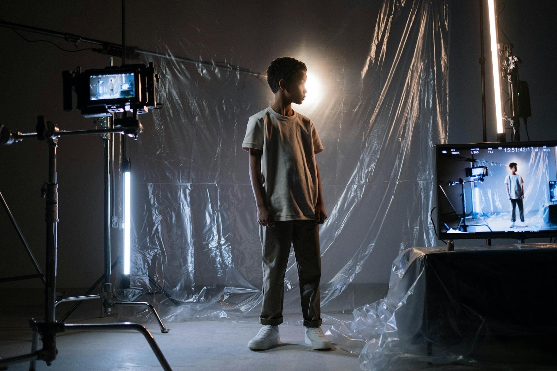 a boy standing near a plastic cover