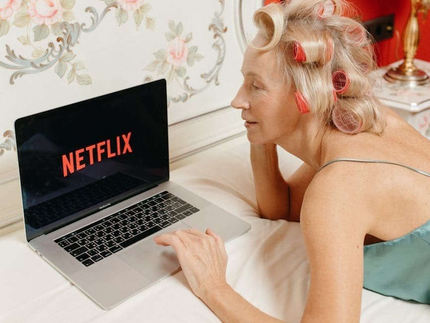 a woman watching on a laptop