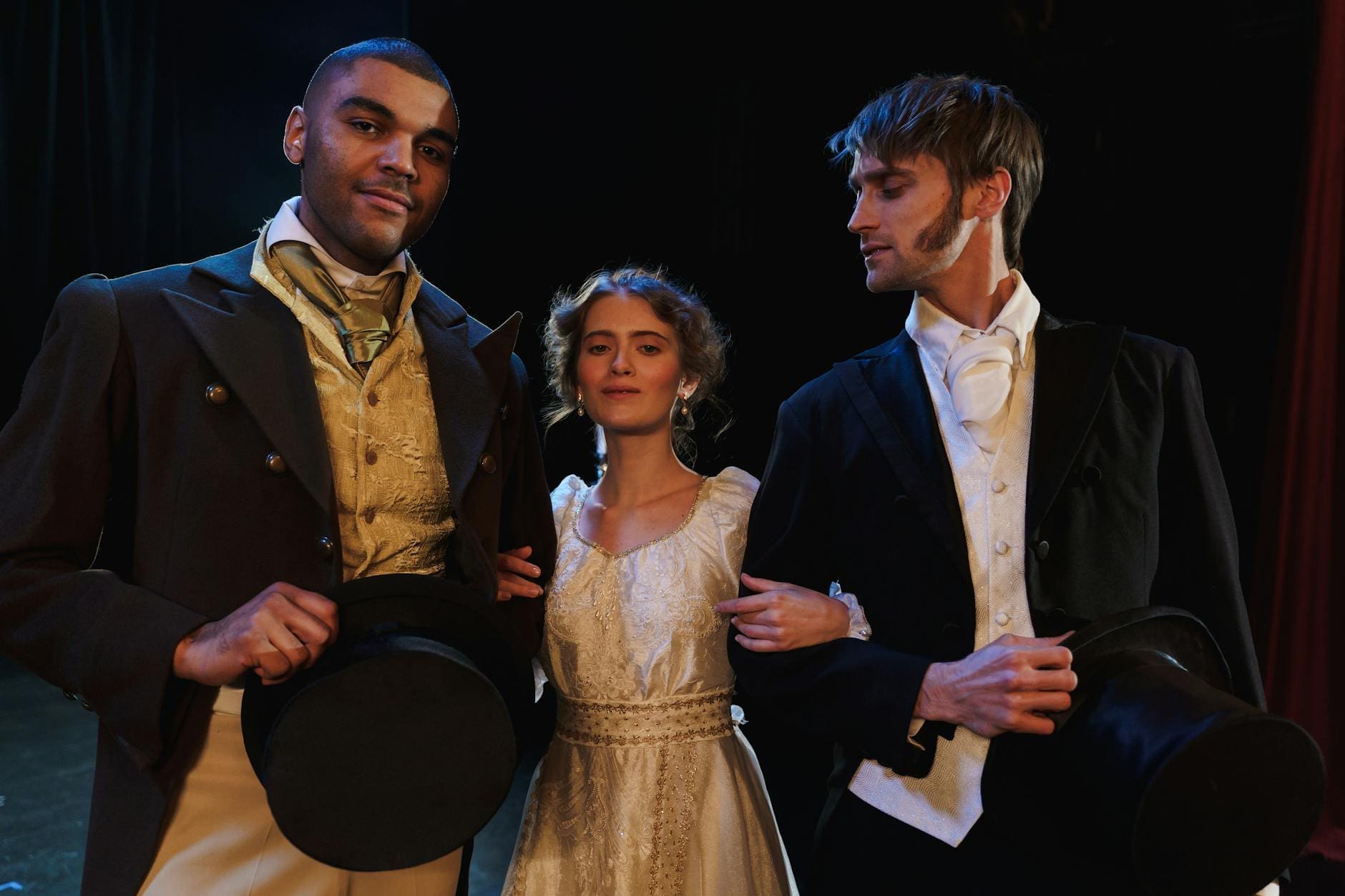 two men and woman wearing different costumes