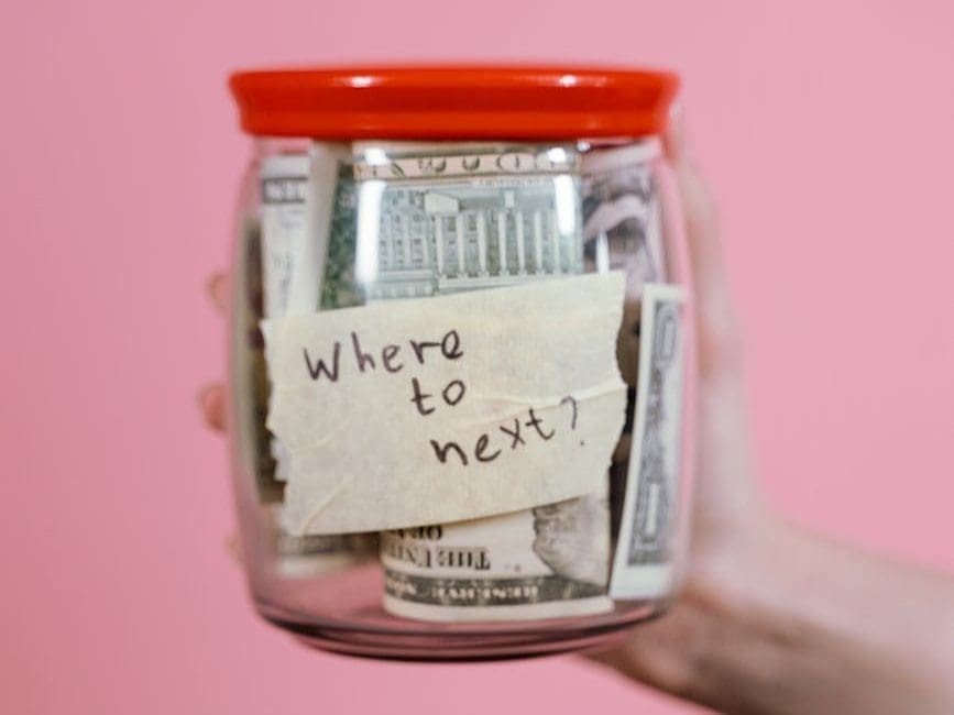 jar full of money held by a person
