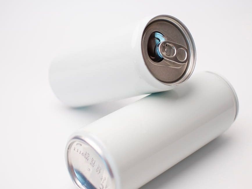 white soda cans on a white surface