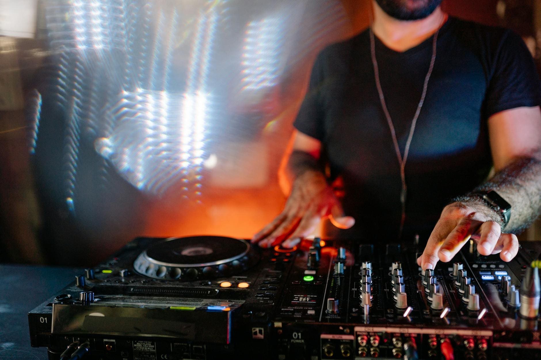 man in black t shirt playing dj mixer