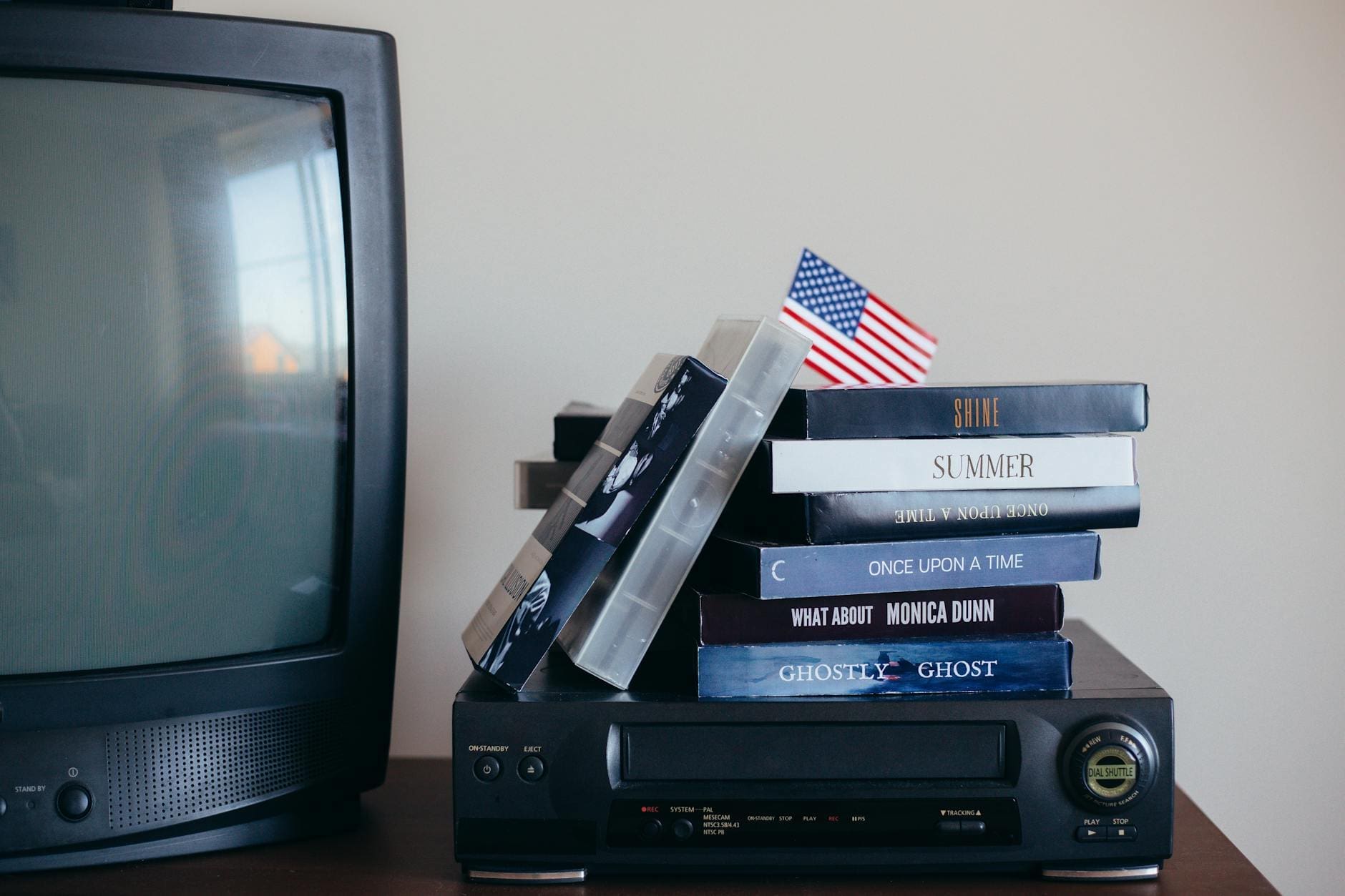 vhs tapes on top of a vhs player