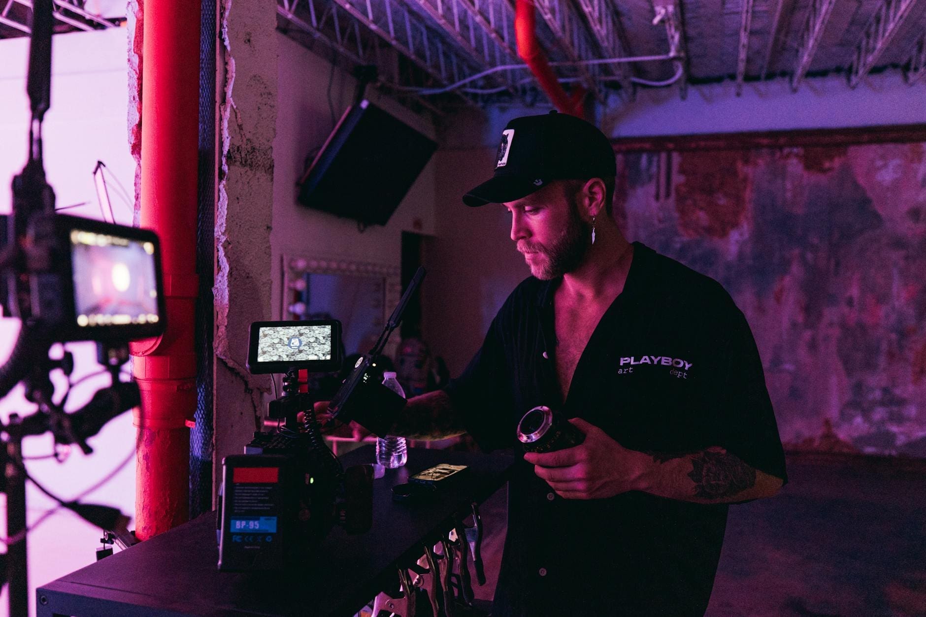 a man holding black camera lens