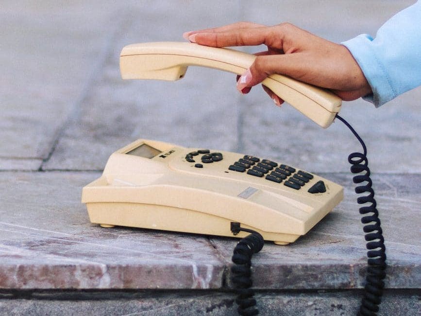 person holding vintage phone