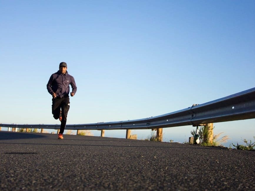 photo of man running during daytime