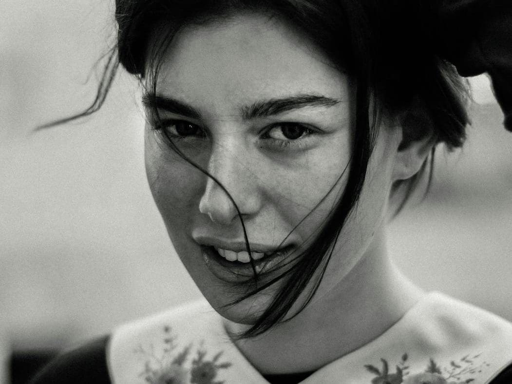 monochrome portrait of a woman with floral collar