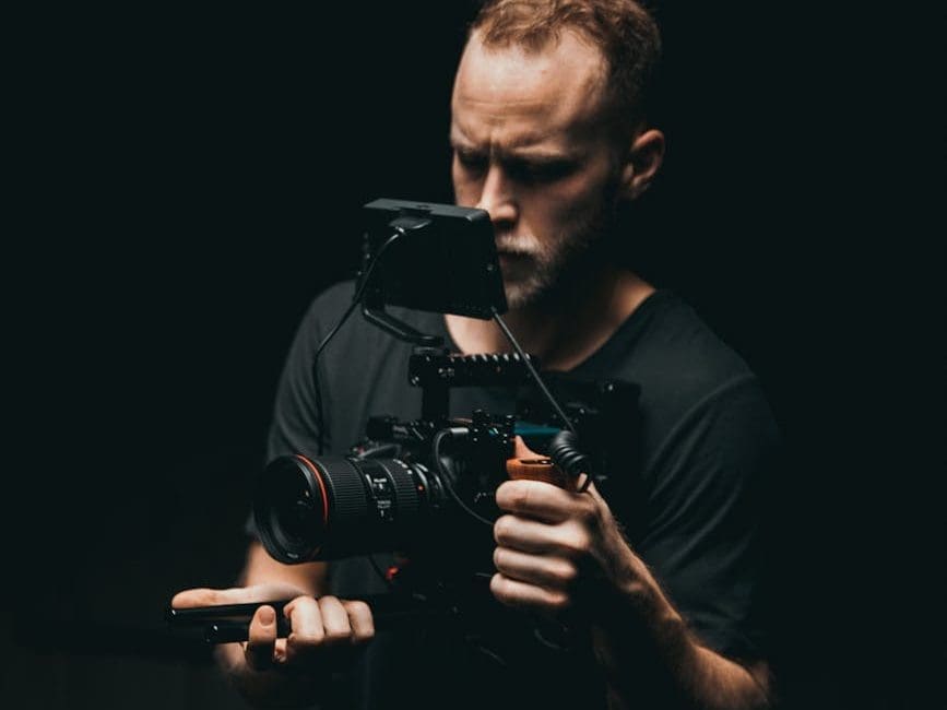 shallow focus photo of man wearing black dslr camera