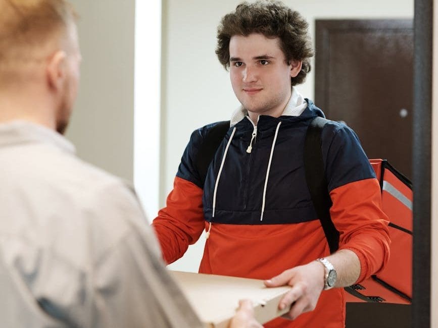 a man delivering a pizza