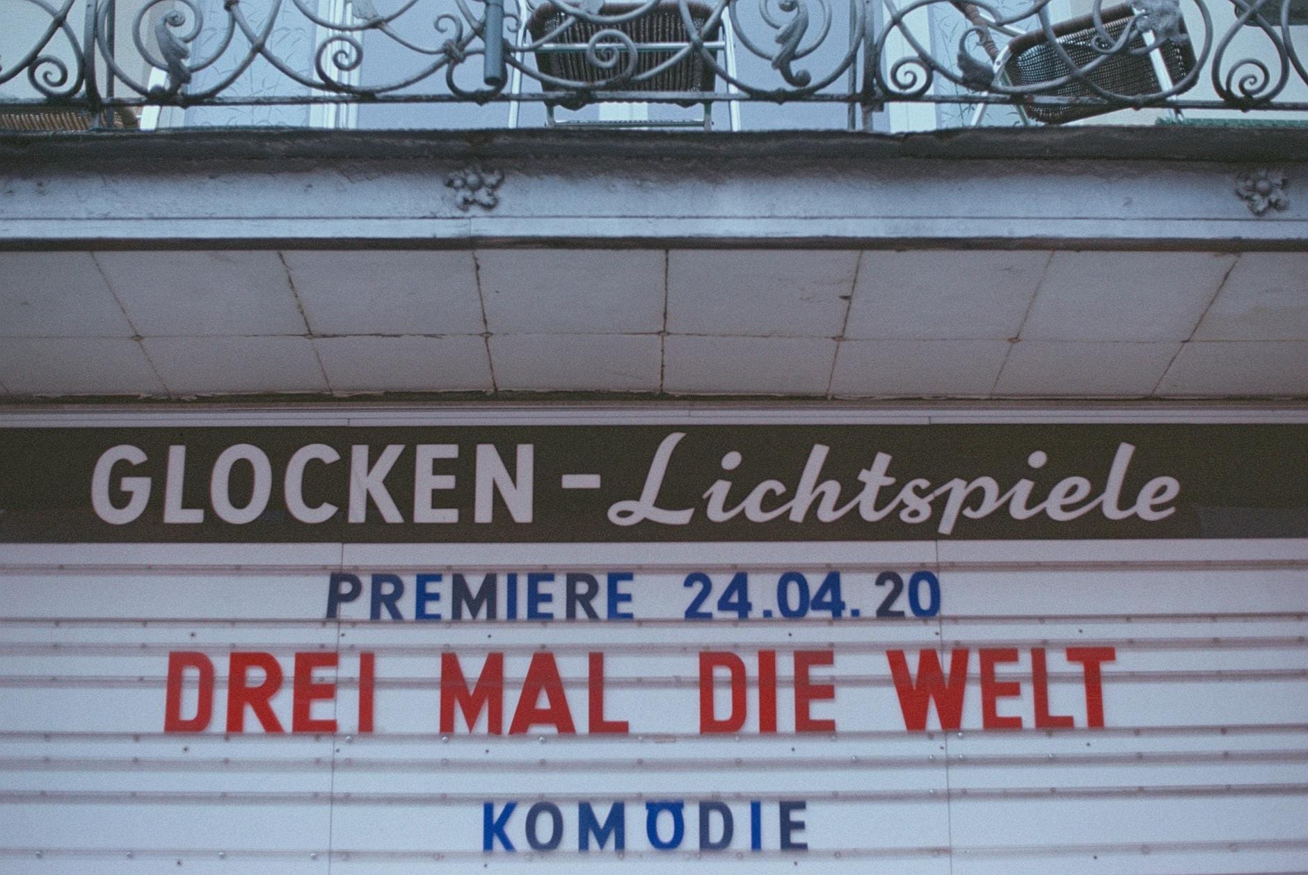 a signboard under a balcony