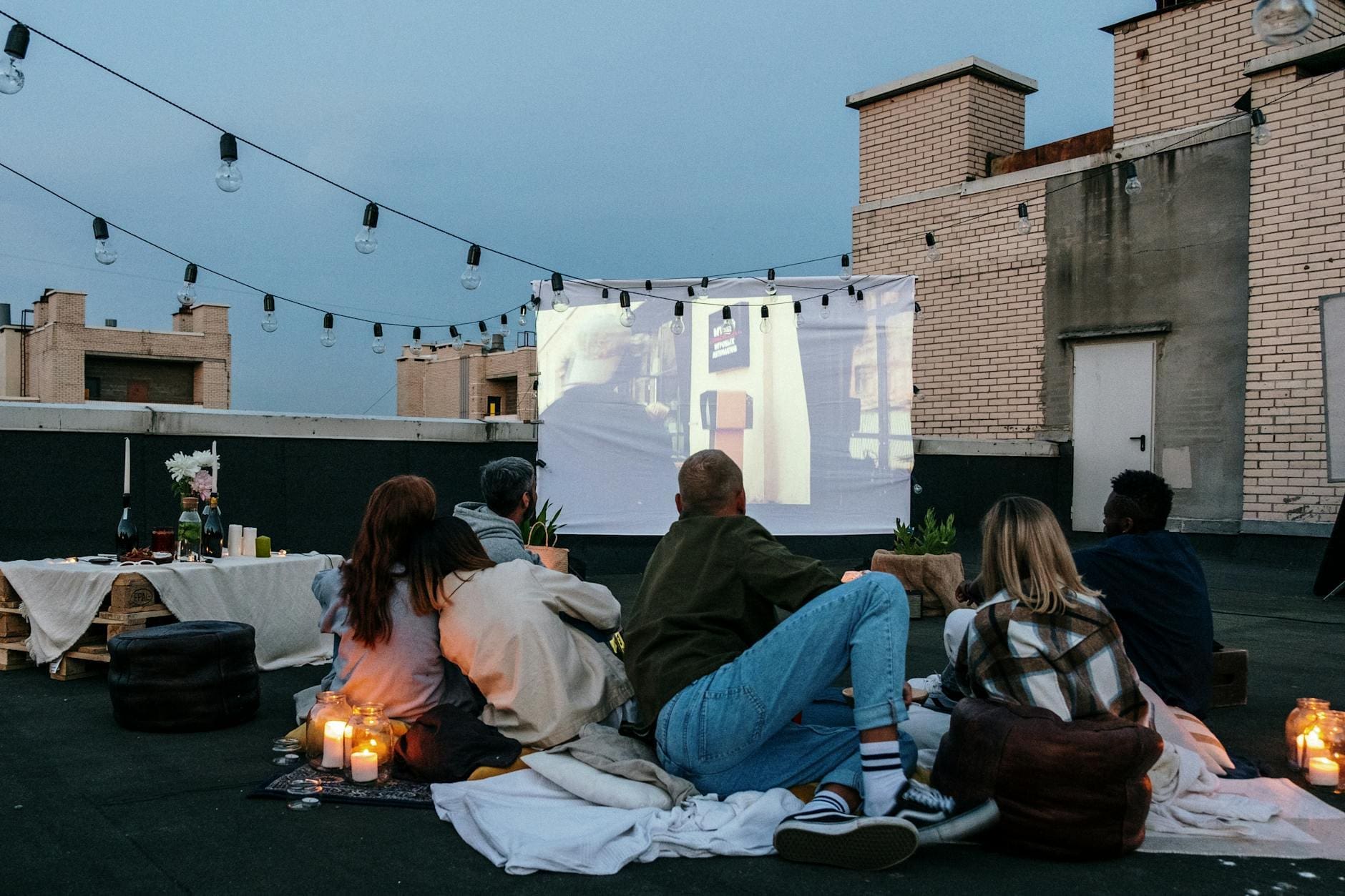 people sitting on the floor near fire pit