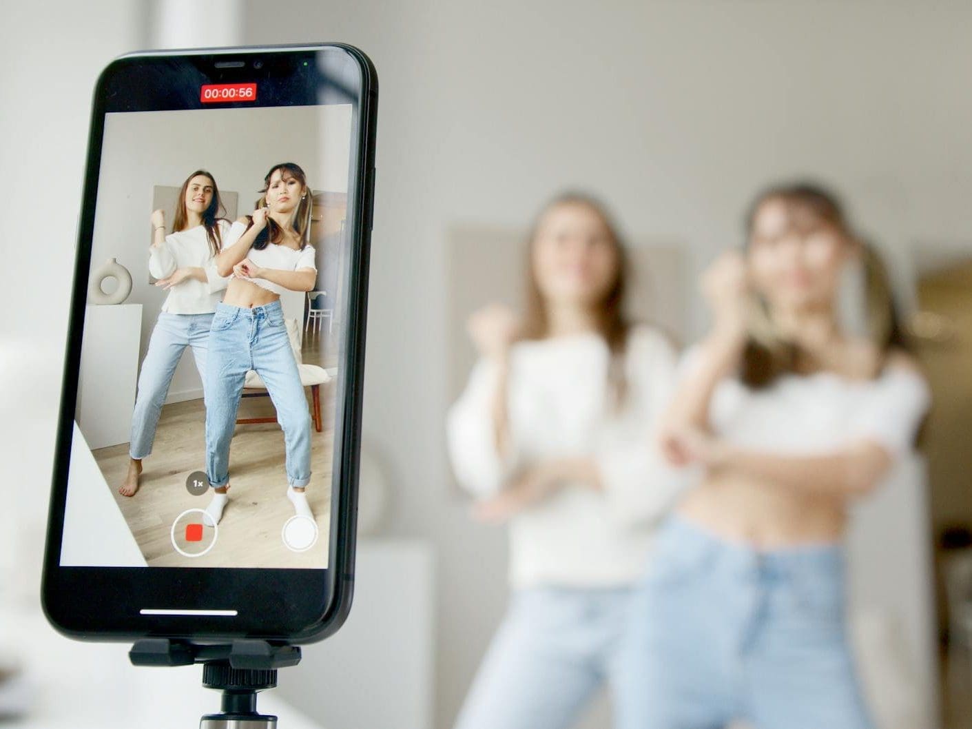 women recording using a smartphone