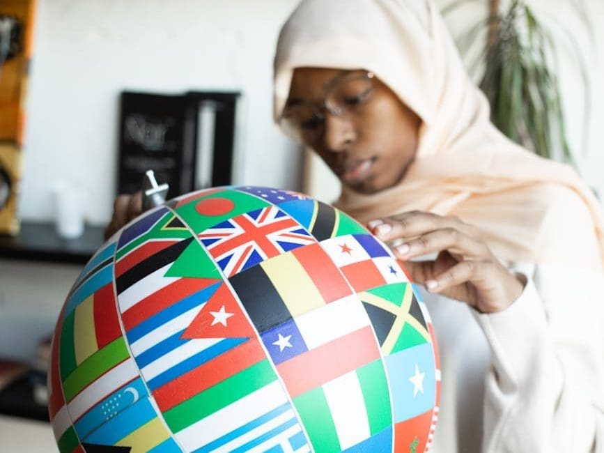 black woman searching country on globe