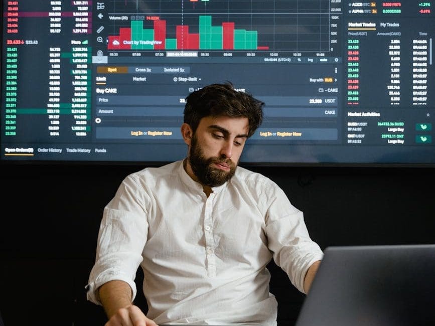 a bearded man working in his office