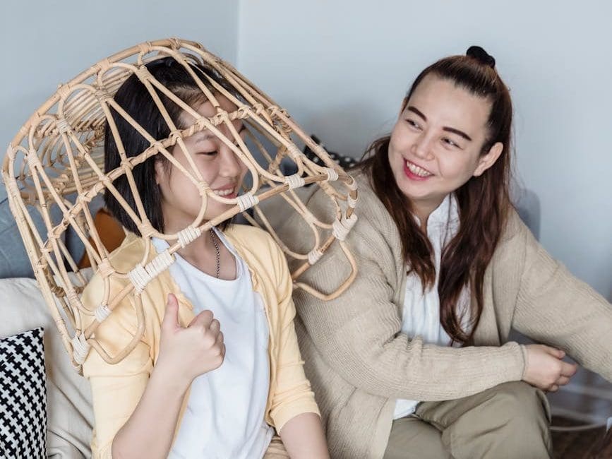 woman and a kid playing with a laundry basket