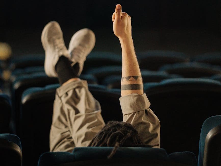 person sitting on a chair and feet on top of the seat