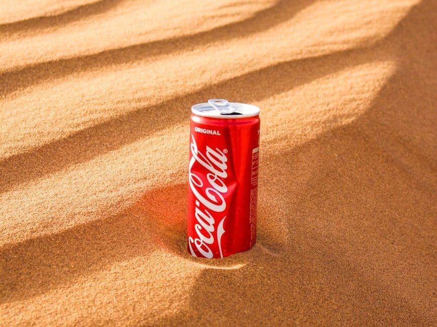 a can of soda on the sand
