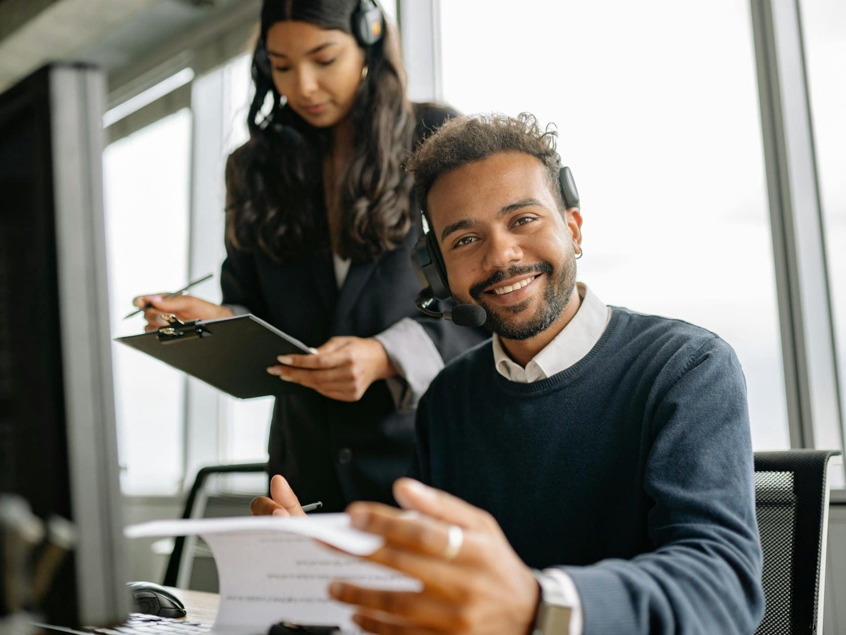 person in blue sweater wearing headset
