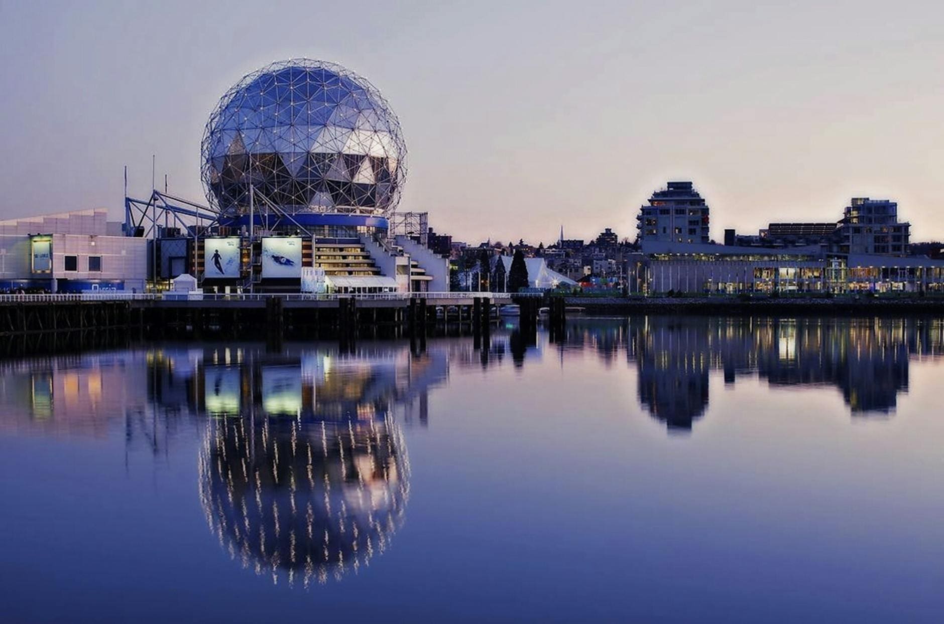 grey dome building beside body of water during sunset