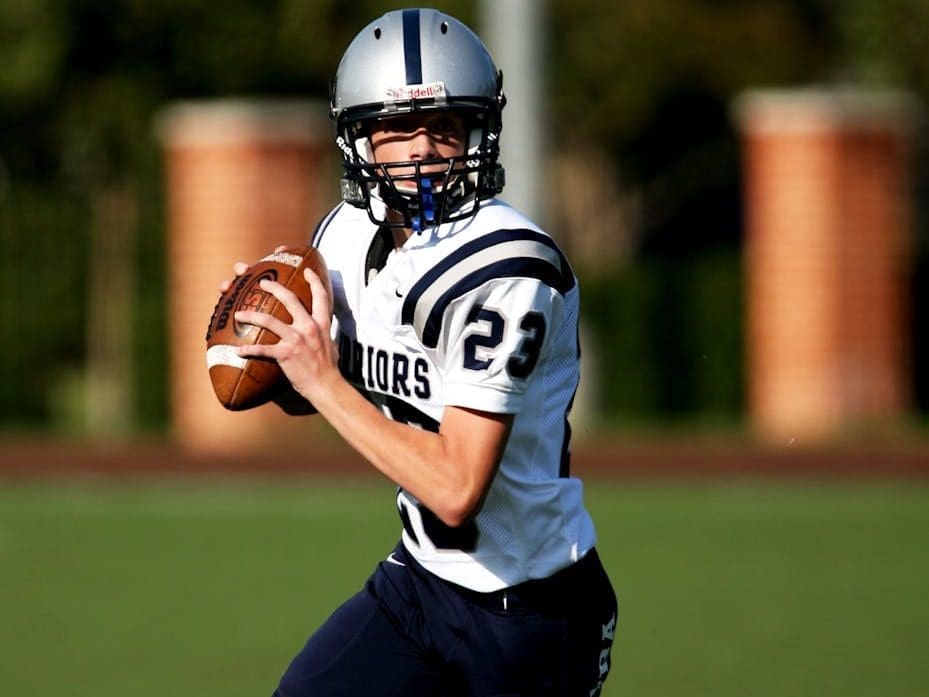 man playing american football on field