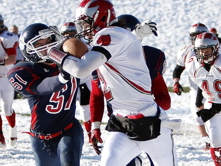 people playing football on snow